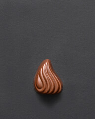 Top view of chocolate praline on dark background