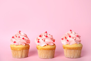 Row of tasty cupcakes on pink background, space for text. Valentine's Day celebration