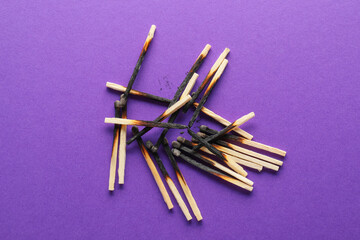 Burnt out matches on color background