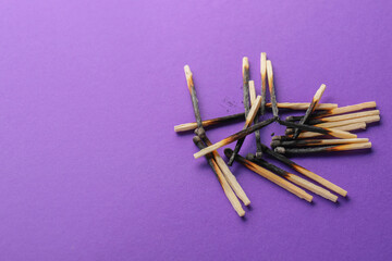 Burnt out matches on color background