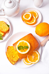 Fototapeta na wymiar Pieces of fresh homemade baked sliced lemon cake on the white plate