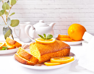 Pieces of fresh homemade baked sliced lemon cake on the white plate