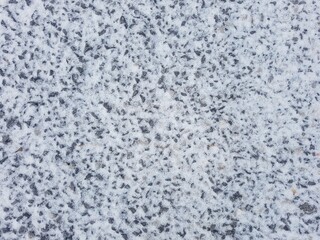 Snow fell on the rocky ground.