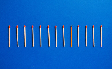 Matches on color background. Concept of uniqueness