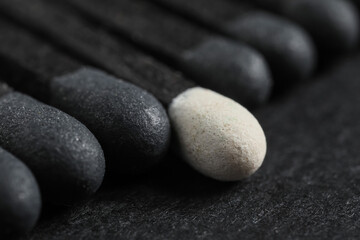 Different matches on dark background, closeup. Concept of uniqueness