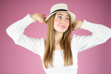 Studio shot of elegant white young girl isolated over pink background.