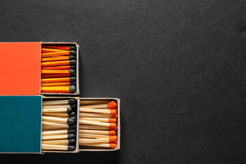 Different boxes with matches on dark background