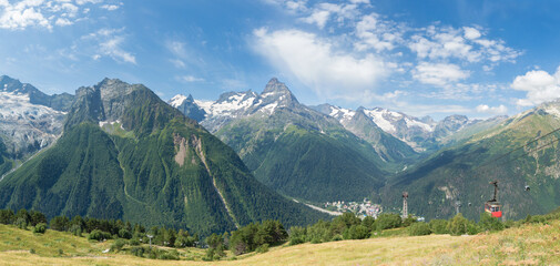 Fototapeta premium Panorama of the valley between the mountains below is a small village