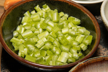 Cut celery in a bowl ready to be used as cooking ingredients