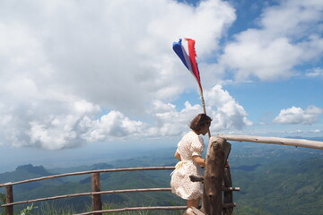 Woman and flag and mountain