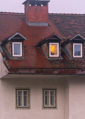 An old european house with a light on