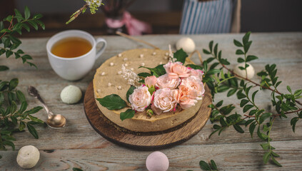 Delicious and beautiful raw cake decorated with tenderness fresh flowers. Concept of romantic mood and spring atmosphere