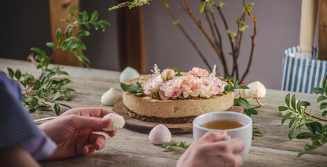 Delicious and beautiful raw cake decorated with tenderness fresh flowers. Concept of romantic mood and spring atmosphere