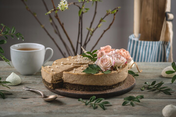 Delicious and beautiful raw cake decorated with tenderness fresh flowers. Concept of romantic mood and spring atmosphere