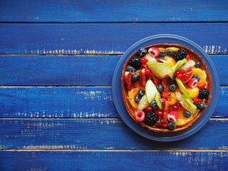 Cake with berries and exotic fruits - raspberry, blueberry, red currant, kiwi, apple, strawberry,...
