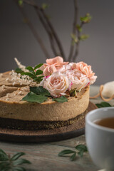 Delicious and beautiful raw cake decorated with tenderness fresh flowers. Concept of romantic mood and spring atmosphere