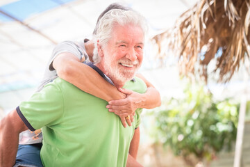 Happy elderly retired lifestyle people with caucasian couple smile and have fun together in...