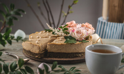 Obraz na płótnie Canvas Delicious and beautiful raw cake decorated with tenderness fresh flowers. Concept of romantic mood and spring atmosphere
