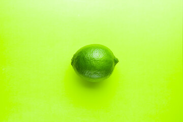 Fresh bright green lime on a green background.