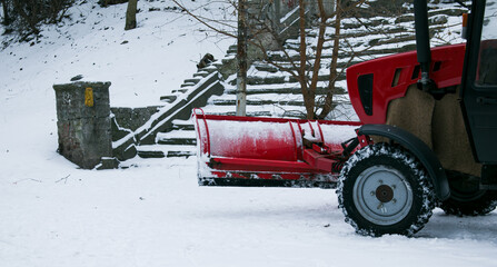 Snowplow removing snow on street after blizzard. Snowplow vehicle clears snowy road during...