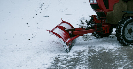 Snowplow removing snow on street after blizzard. Snowplow vehicle clears snowy road during...