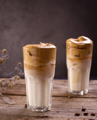 Dalgona Coffee. Whipped icing drink with instant coffee popular in Korea Creamy cocktail in tall Glasses.