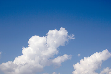 Naklejka na ściany i meble Blue sky with white clouds background texture.