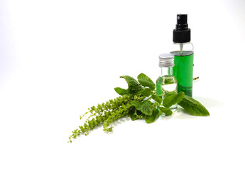 Herbs, volatile oils in bottles and leaves, isolated on white background.