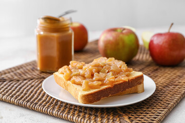 Toast with sweet apple jam on light background
