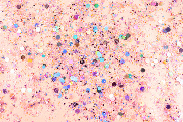 Shiny glitter on light pink background, top view