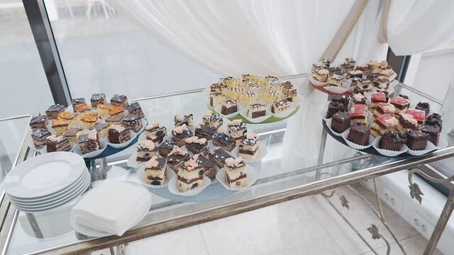 lots of sweet cakes on the buffet table