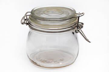 empty glass jar for storing food, on a white background