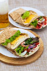 tortillas in envelopes, stuffed with shrimp and vegetables, parmesan and tuna fillet meat, beer snack, fajita wrap sandwich