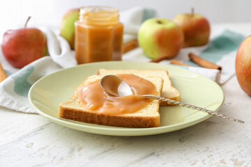 Toast with sweet apple jam on light background