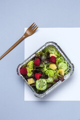 Healthy vegan take away salad in aluminum container