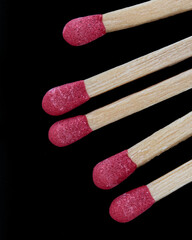 macro of five matches isolated on a black background