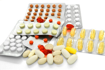 Different medicines and pills on white background