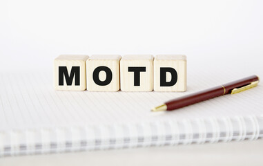 motd written word. cubes, notepad and pen.. You can use in business, marketing and other concepts. Messege of the day.