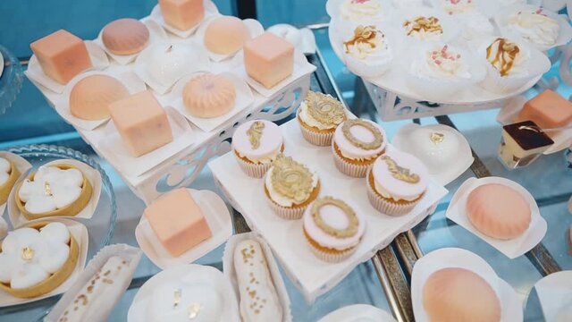 lots of sweet cakes on the buffet table