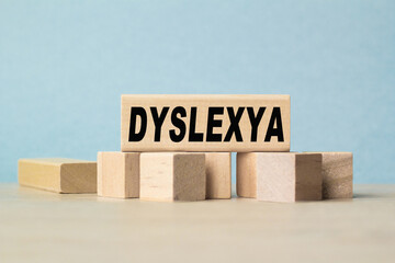 the word DYSLEXYA is written on a wooden cubes structure . Cube on a bright background. Can be used for Medical concept. the medicine.