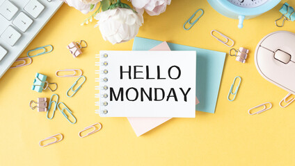 Hello monday, Blank album paper with hello monday inscription on table with office items