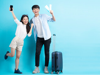 Young couple preparing to travel over blue background