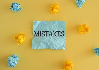 Mistakes word written on colorful notes.Conceptual photo Something not correct Lack of accuracy Wrong Incorrect Fail. Colored crumpled reminder paper, yellow background.