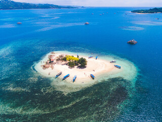 Aerial view of Gili Kedis in Lombok, Indonesia. Beautiful small island with white sandy beach and blue sea water.
