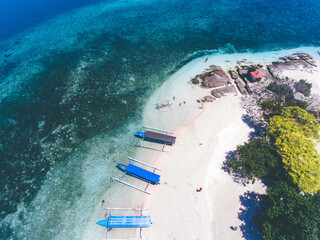 Top view of Gili Kedis in Lombok, Indonesia. Beautiful small island with white sandy beach and blue sea water.