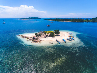 Aerial view of Gili Kedis in Lombok, Indonesia. Beautiful small island with white sandy beach and blue sea water.