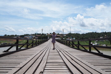 Woman on wooden bridge at Kanchanaburi, Thailand.