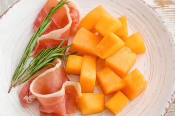 Plate with delicious melon and prosciutto, closeup