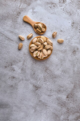 Organic pistachio nuts in bowl on table.