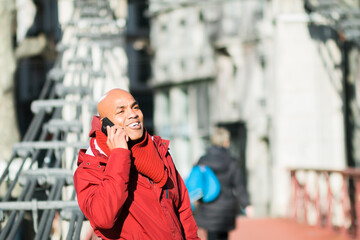 Fototapeta premium Concept of business, technology, communication and people - smiling businessman with smart phone talking on city background.